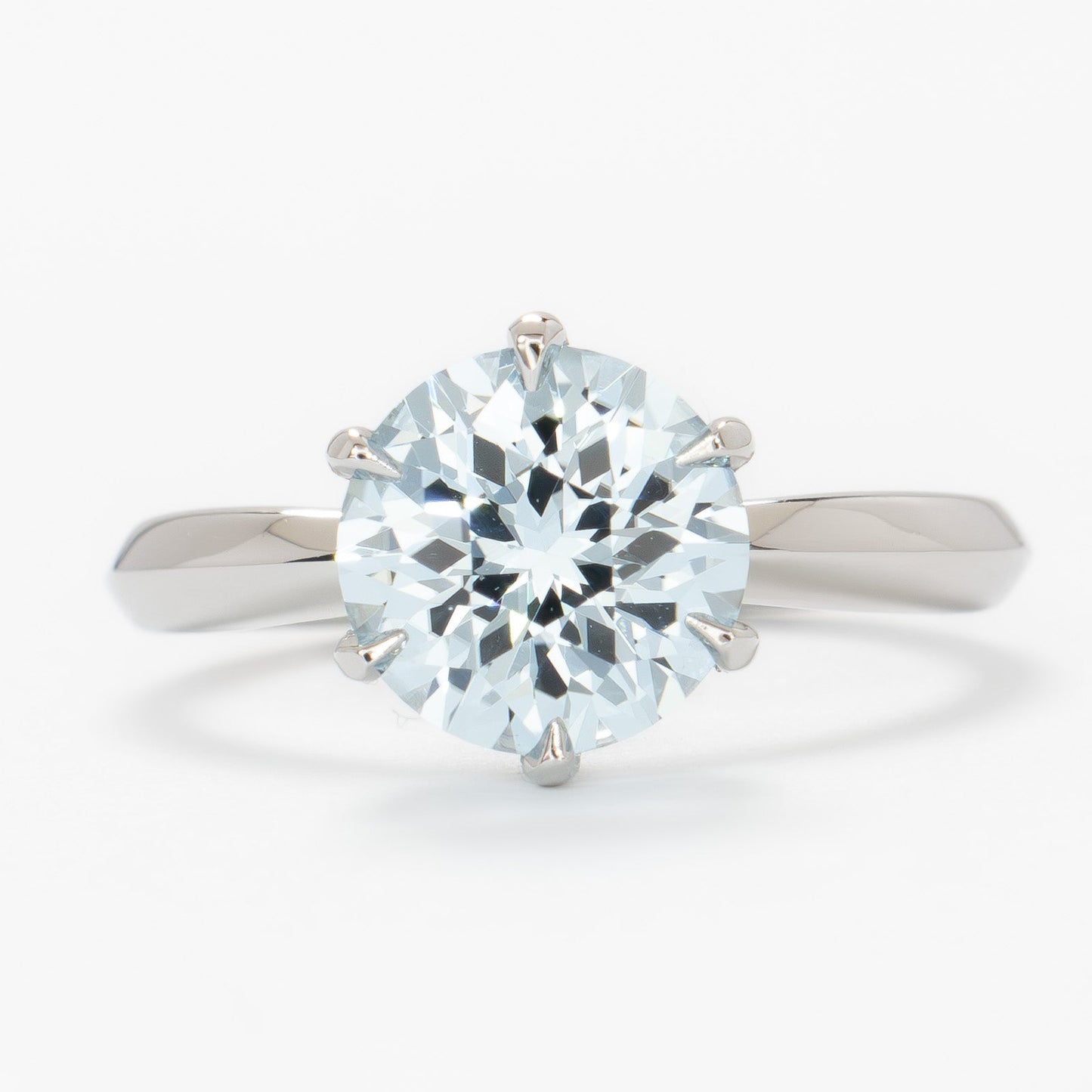 charlotte solitaire engagement ring with round light blue lab sapphire