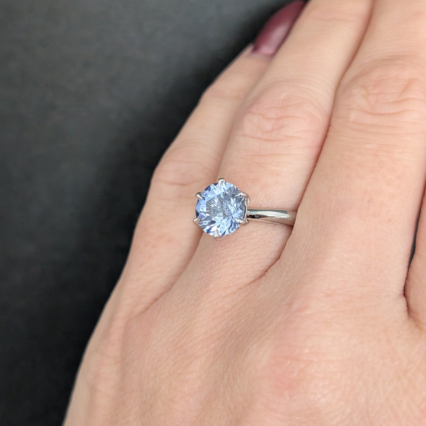 charlotte solitaire engagement ring with round light blue lab sapphire