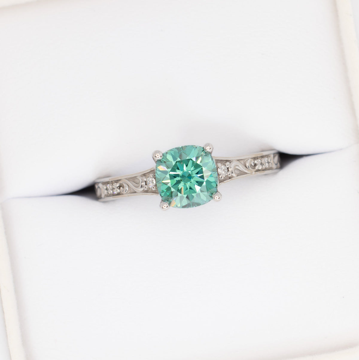 clementine ring in white gold with green moissanite cushion