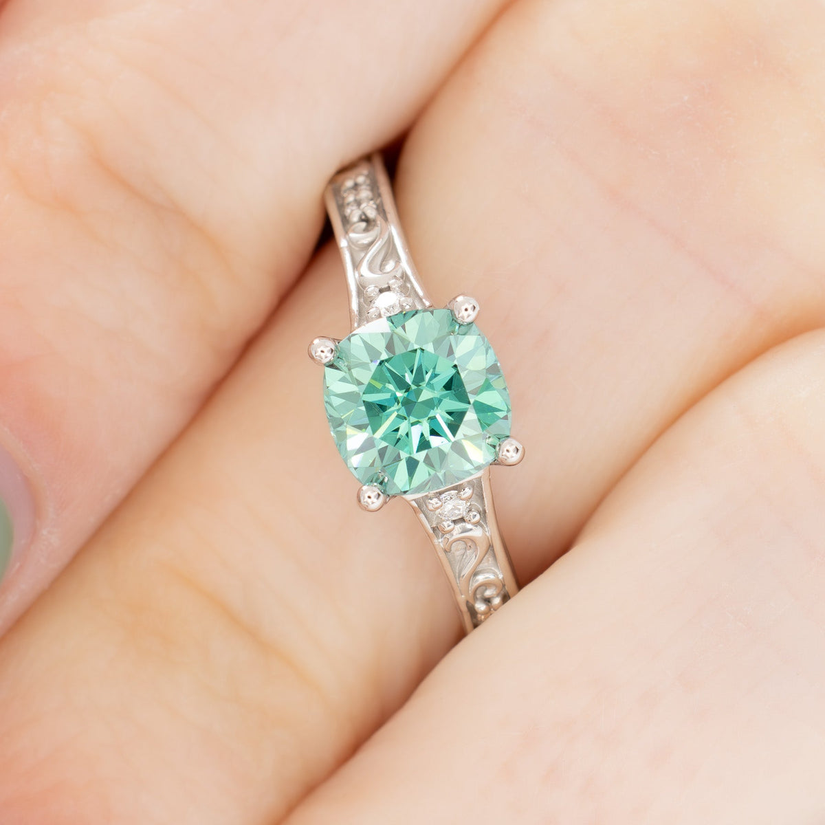 clementine ring in white gold with green moissanite cushion