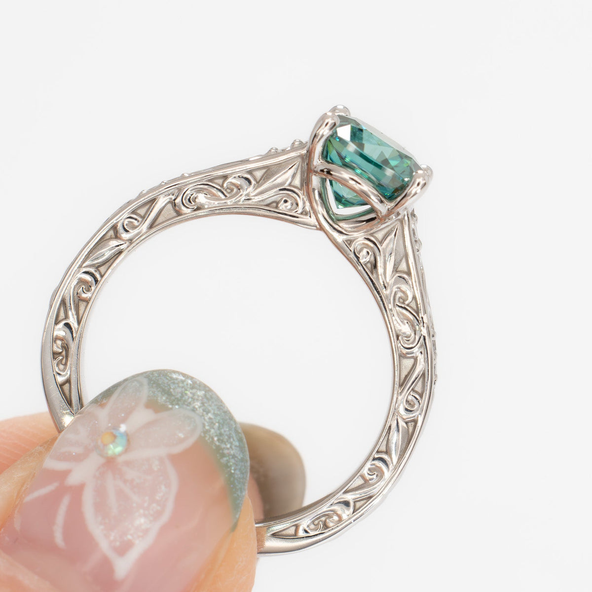 clementine ring in white gold with green moissanite cushion
