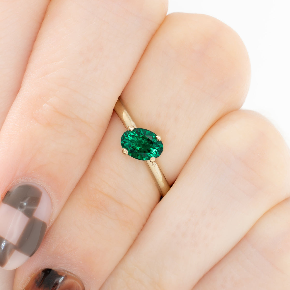 compass set solitaire ring in yellow gold with oval lab emerald