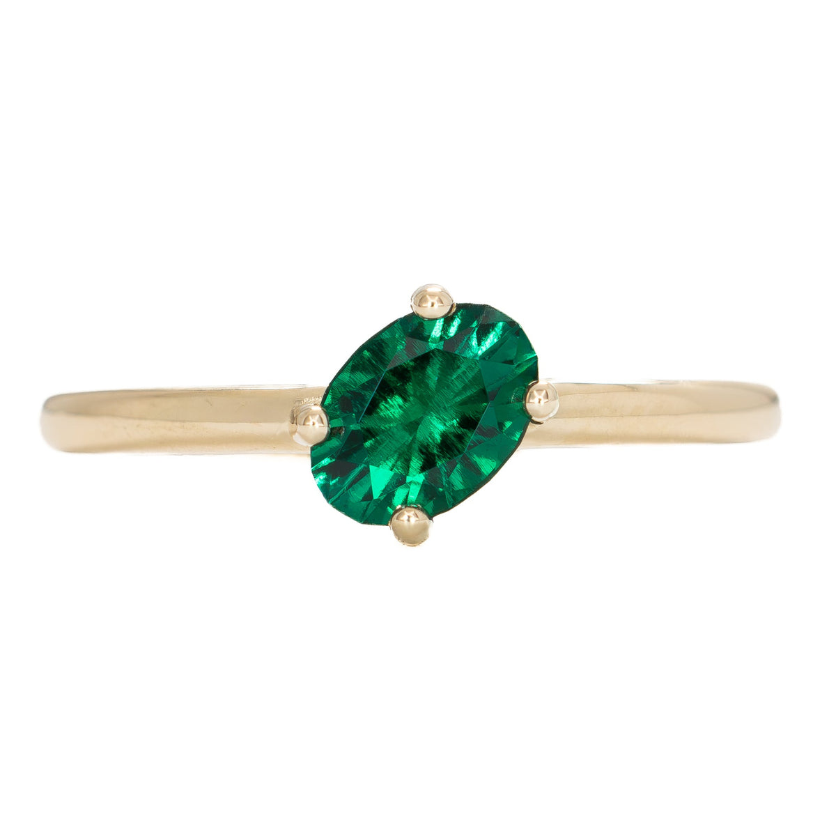 compass set solitaire ring in yellow gold with oval lab emerald