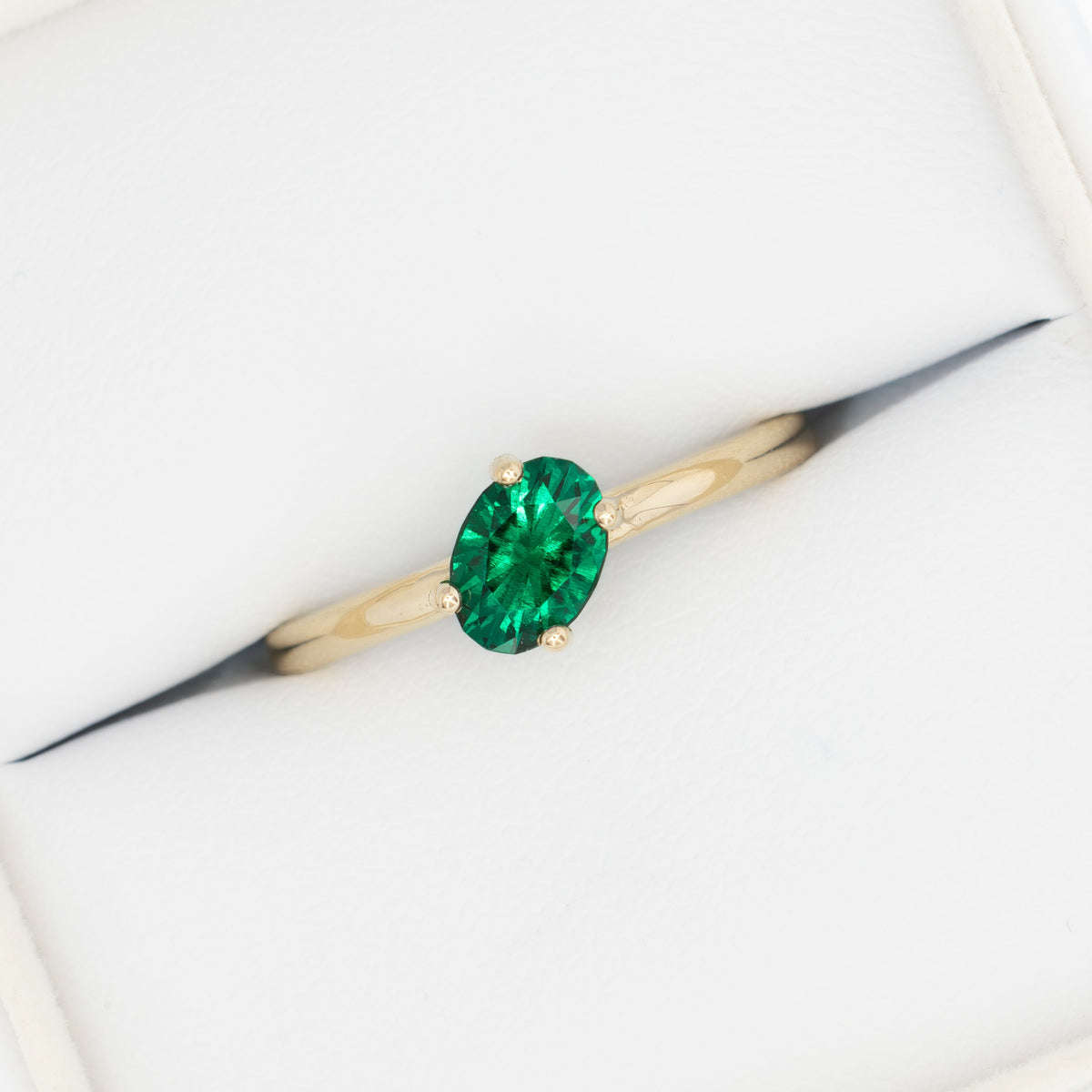 compass set solitaire ring in yellow gold with oval lab emerald