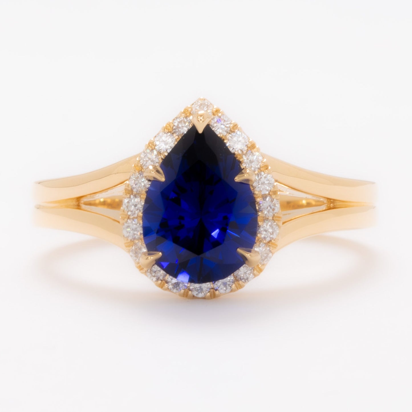 cove halo split shank engagement ring with blue pear lab sapphire