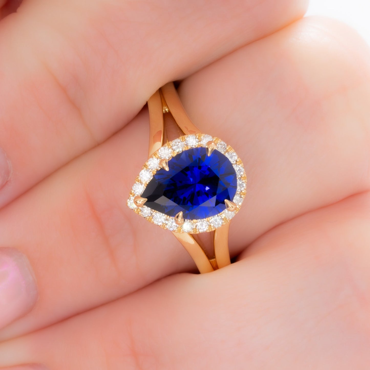 cove halo split shank engagement ring with blue pear lab sapphire