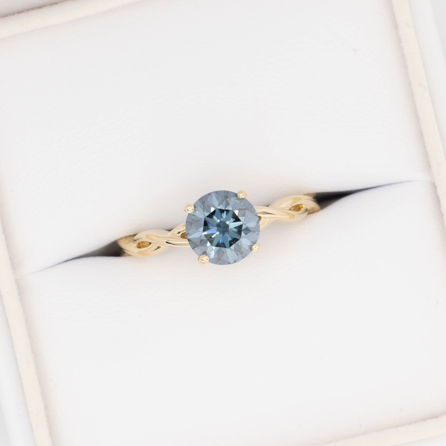 cressida solitaire engagement ring in yellow gold with blue moissanite round brilliant