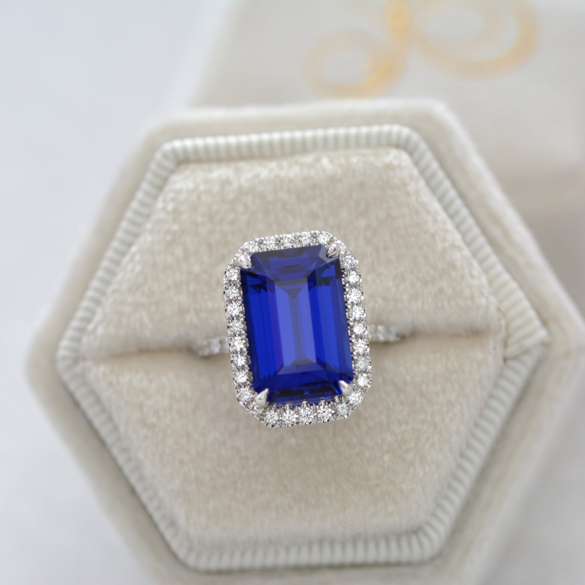 large blue step cut lab sapphire ring with halo