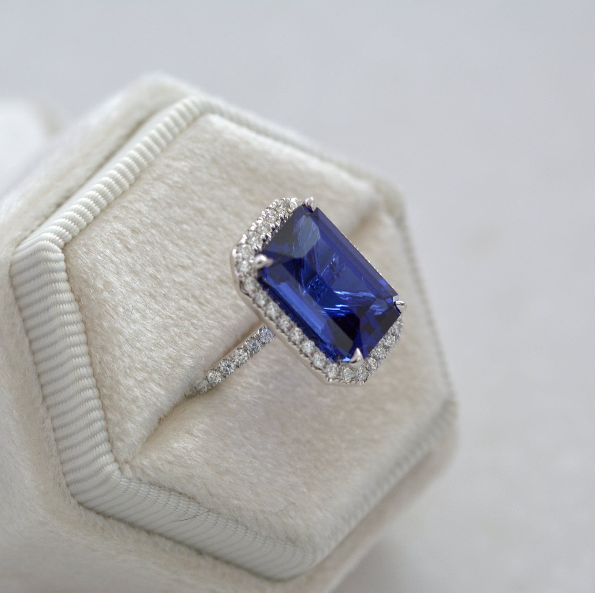 large blue step cut lab sapphire ring with halo