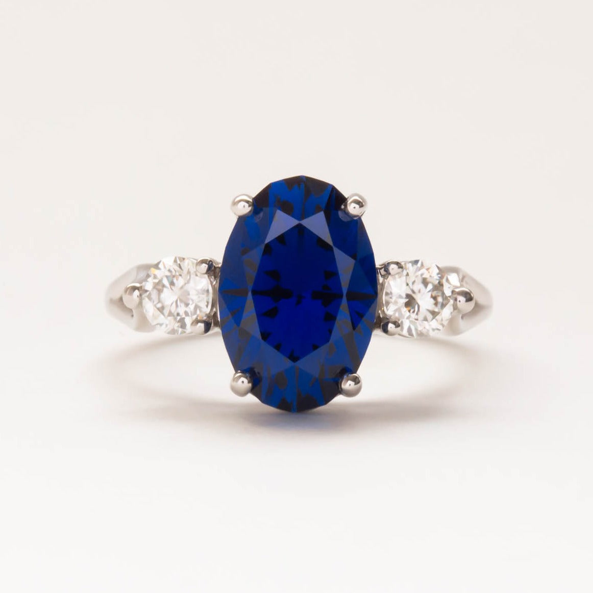 oval royal blue lab sapphire three stone engagement ring