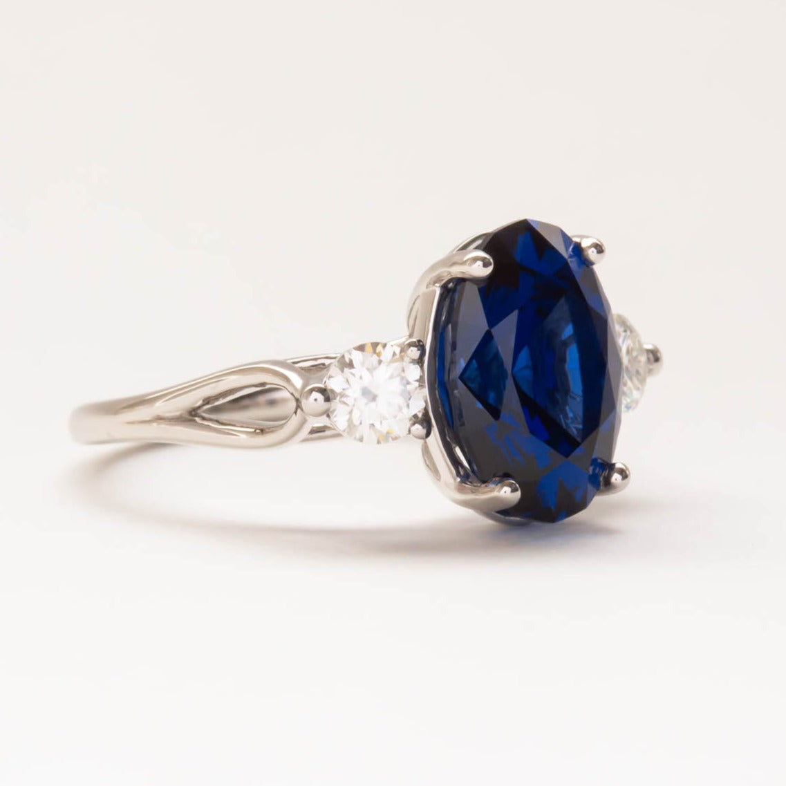 oval royal blue lab sapphire three stone engagement ring