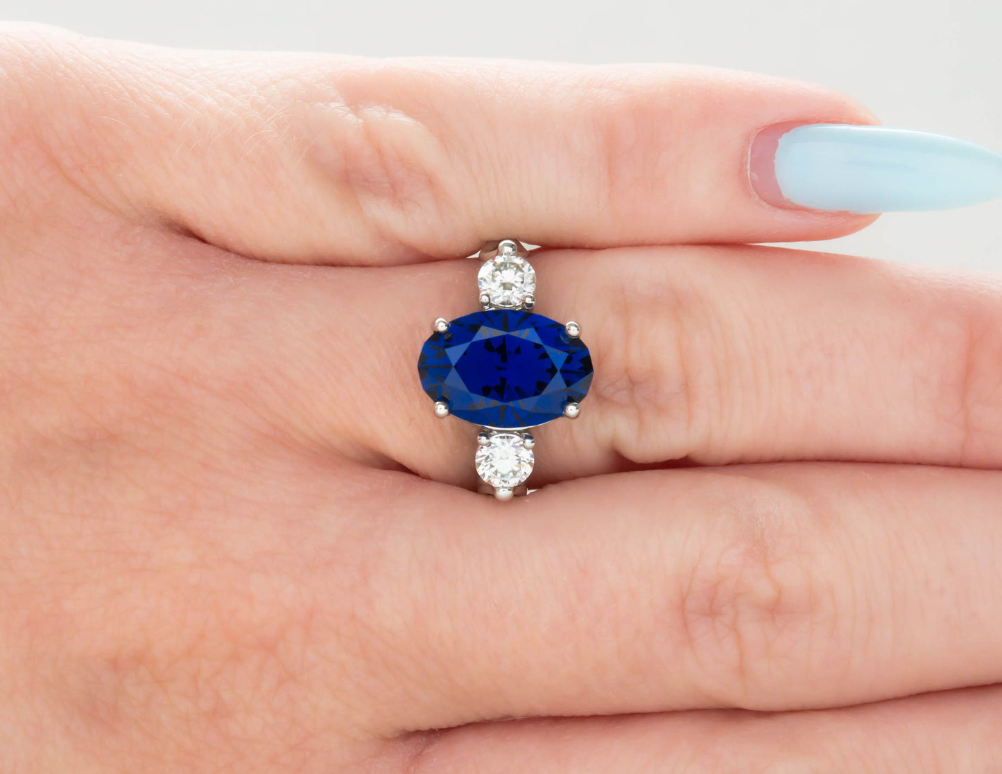 oval royal blue lab sapphire three stone engagement ring