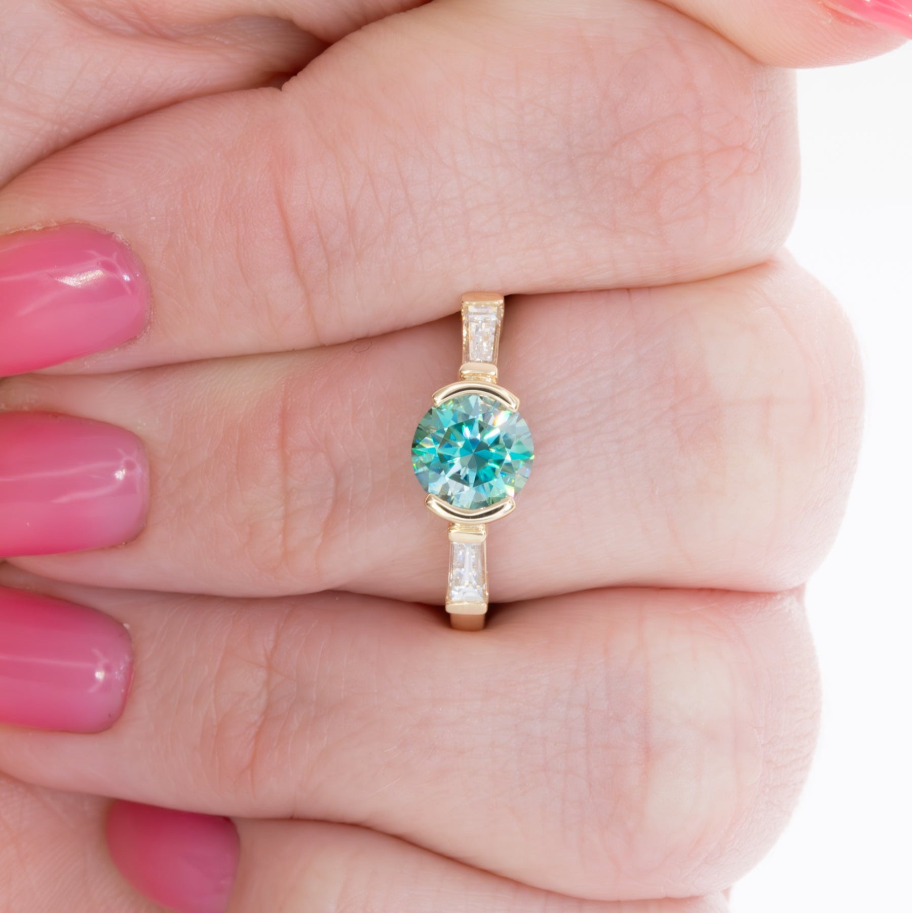 ezri three stone engagement ring with round blue-green moissanite