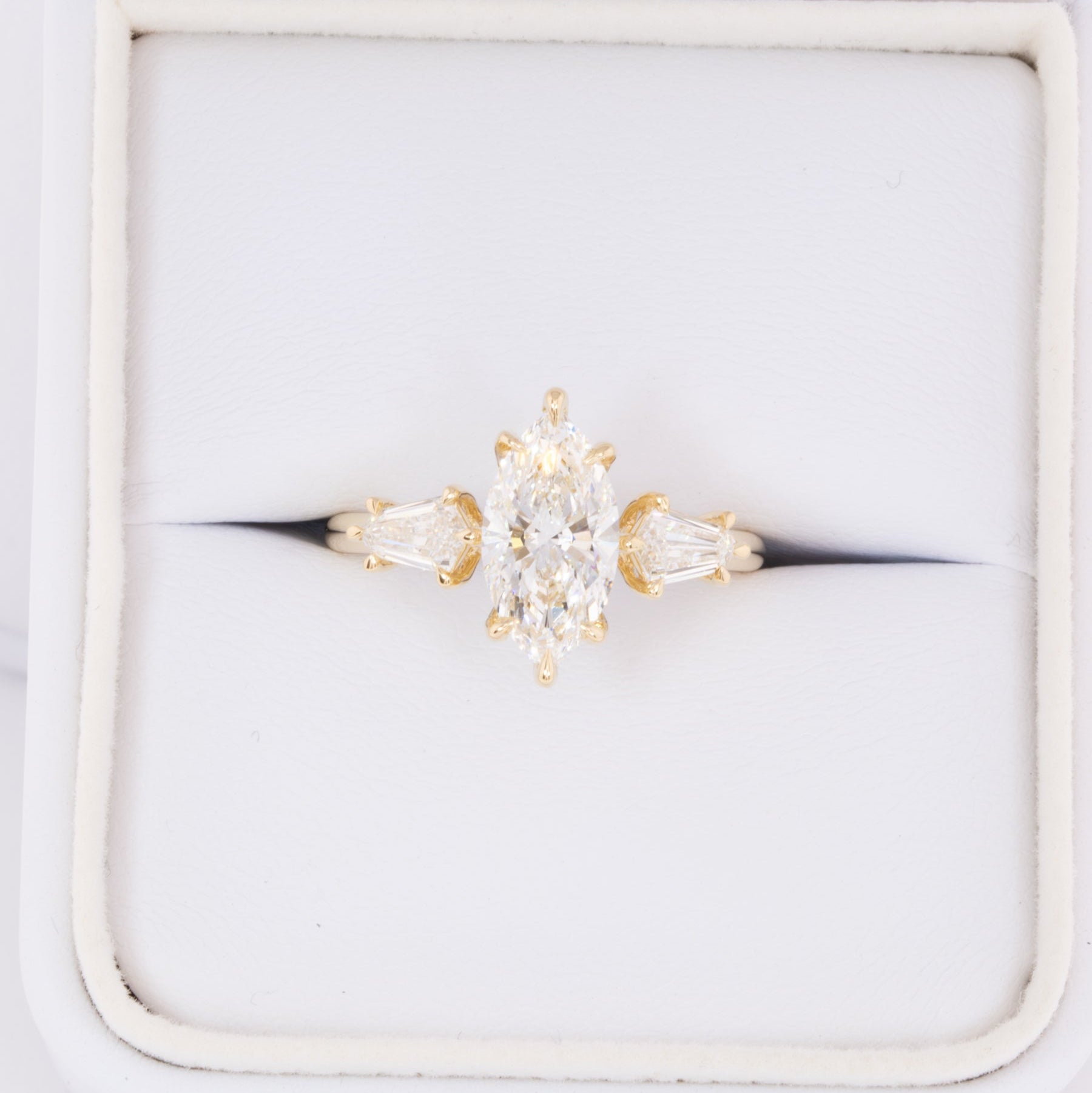 felicity three stone engagement ring with marquise lab diamond
