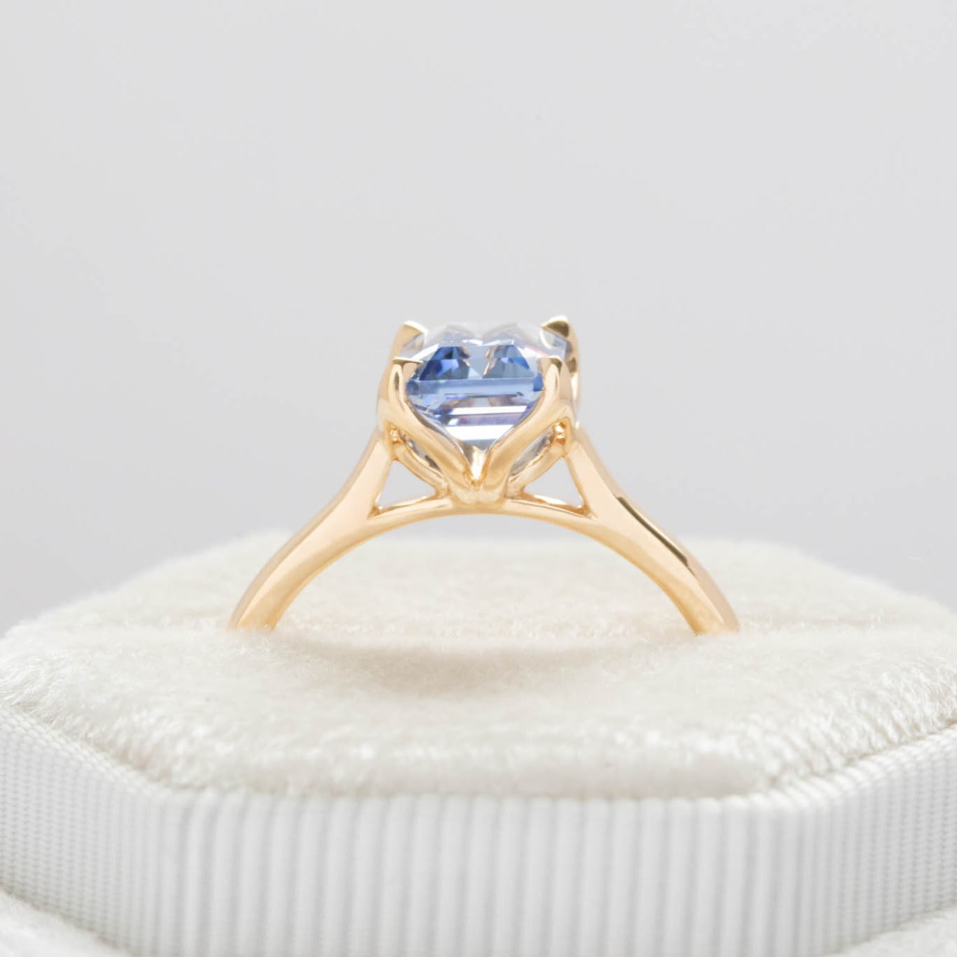 floral inspired solitaire engagement ring with step cut lab sapphire