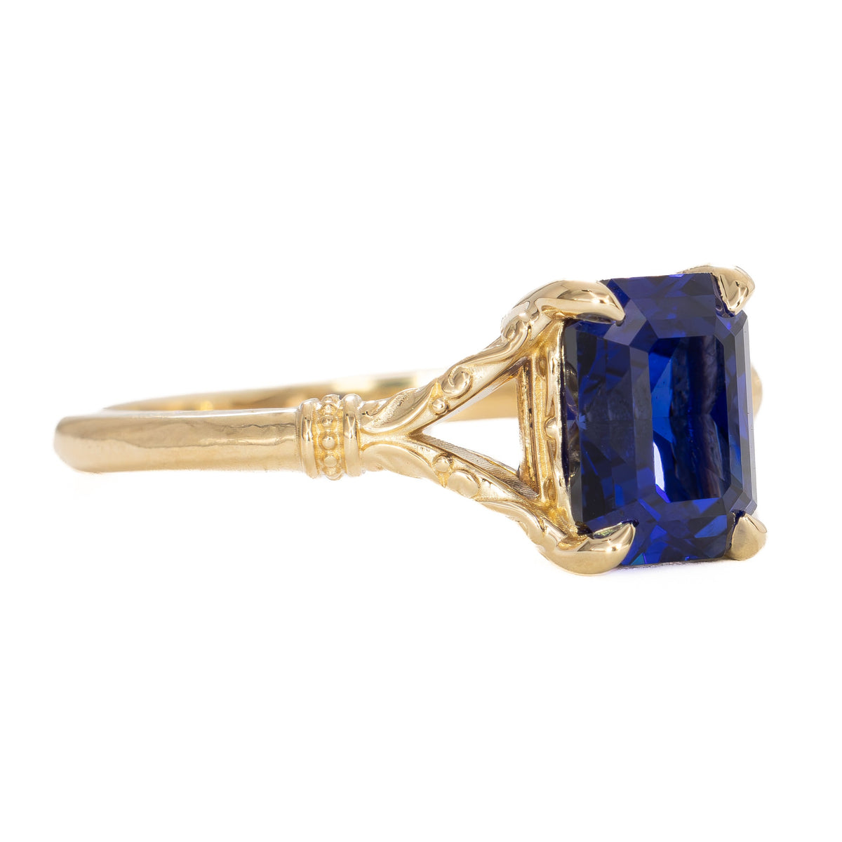jasmine split shank solitaire ring in yellow gold with radiant royal blue lab sapphire