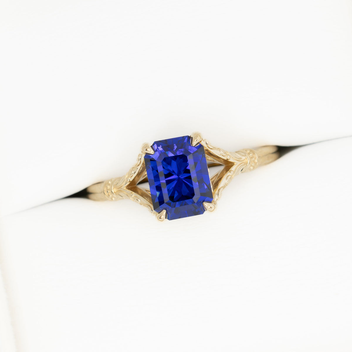 jasmine split shank solitaire ring in yellow gold with radiant royal blue lab sapphire