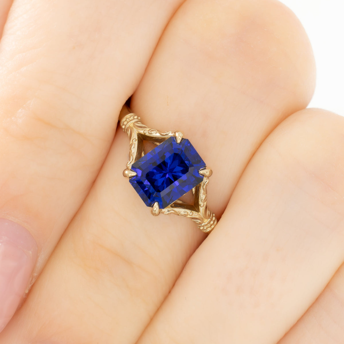 jasmine split shank solitaire ring in yellow gold with radiant royal blue lab sapphire