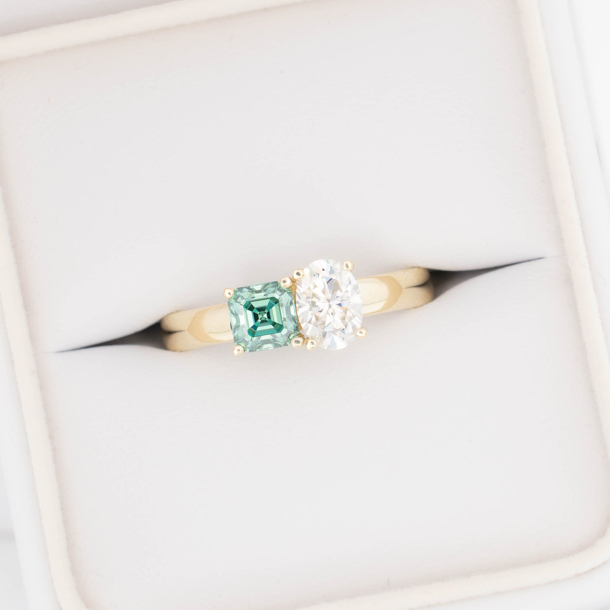 jiva  toi et moi ring with oval white moissanite and asscher green moissanite