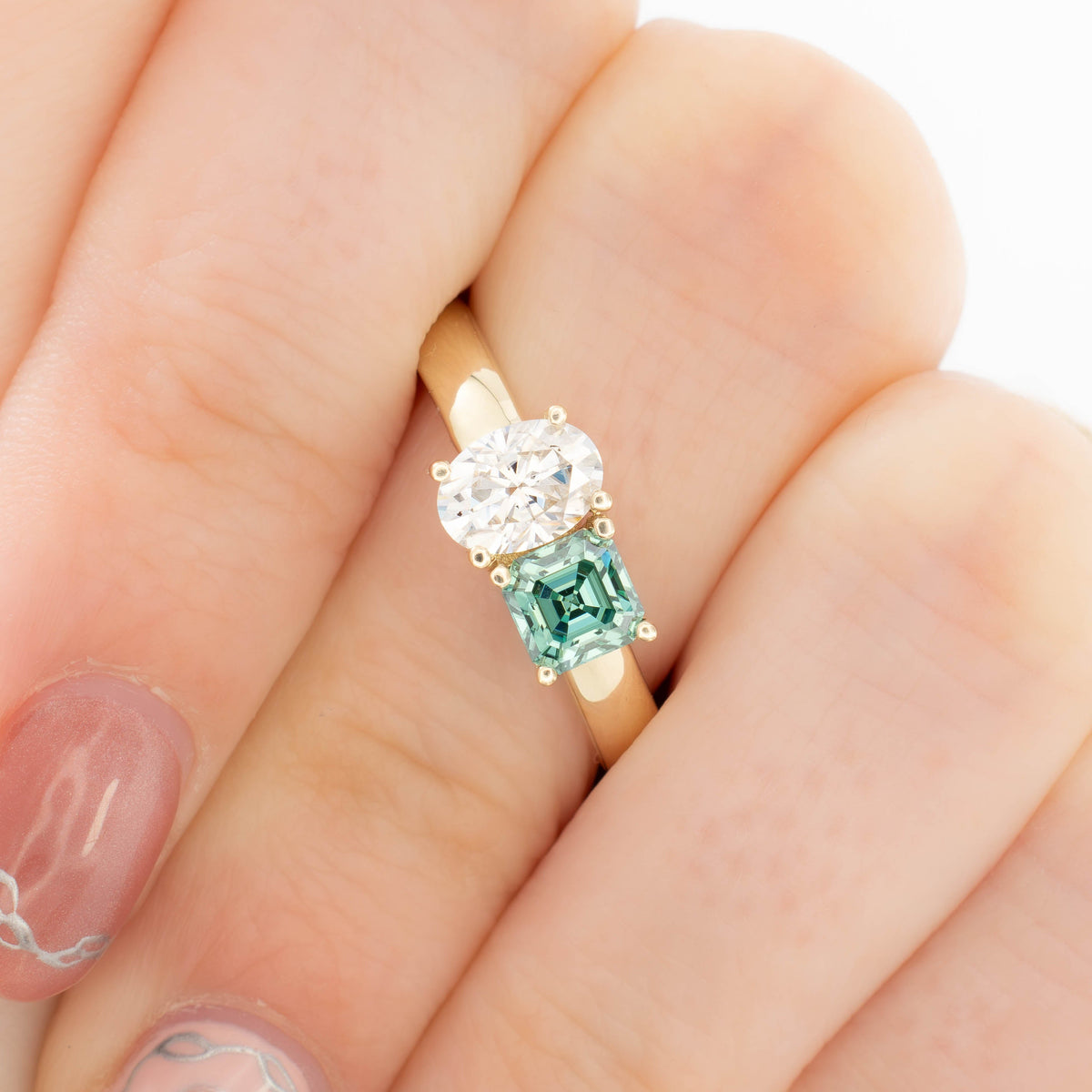 jiva toi et moi ring with oval white moissanite and asscher green moissanite