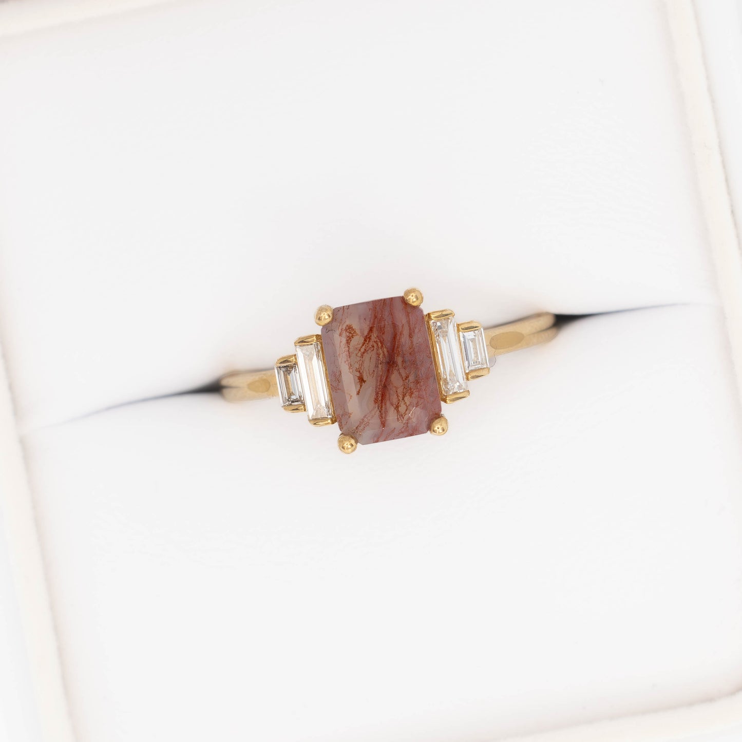 journey ring with step cut red moss agate in yellow gold
