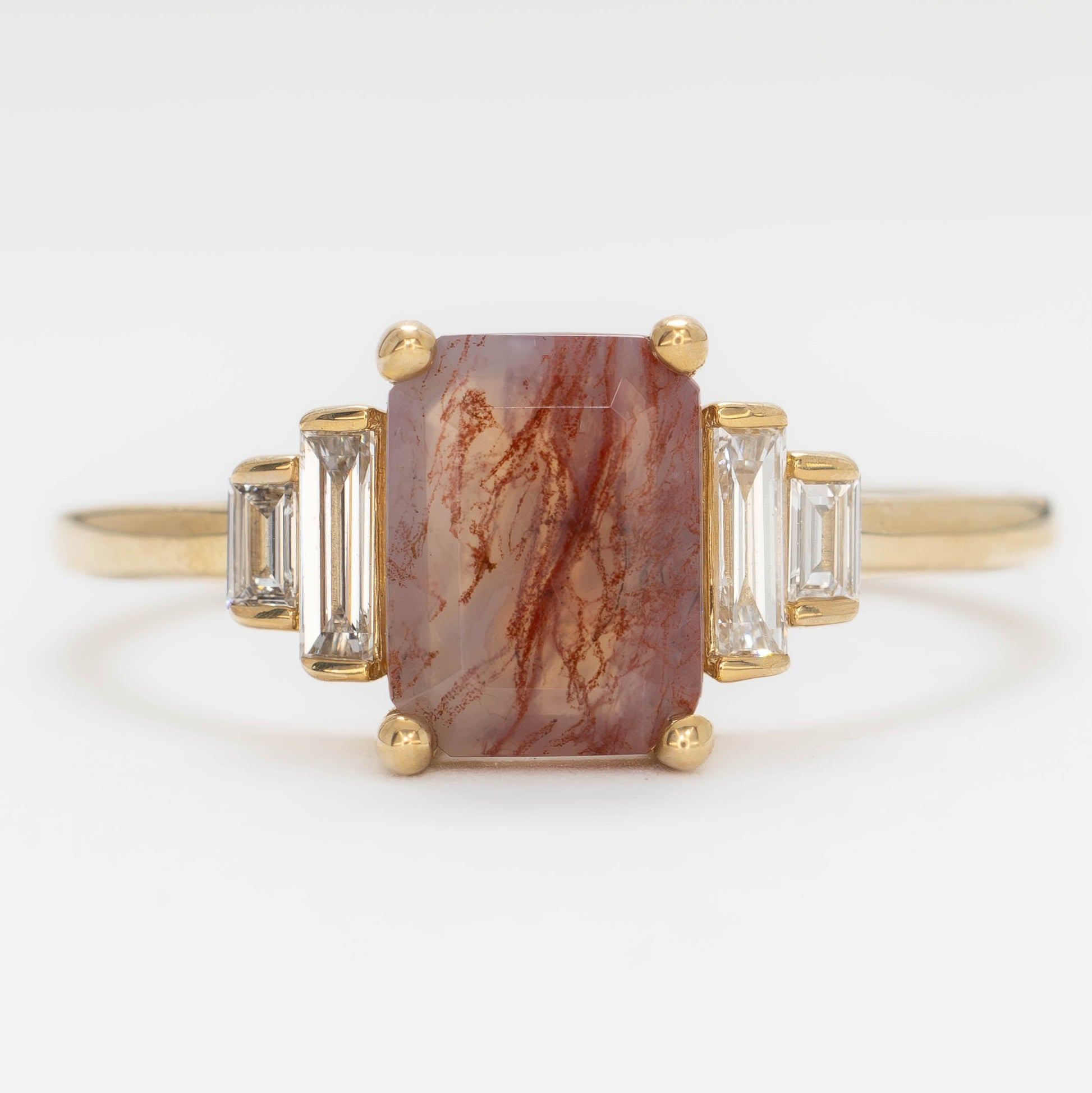 journey ring with step cut red moss agate in yellow gold