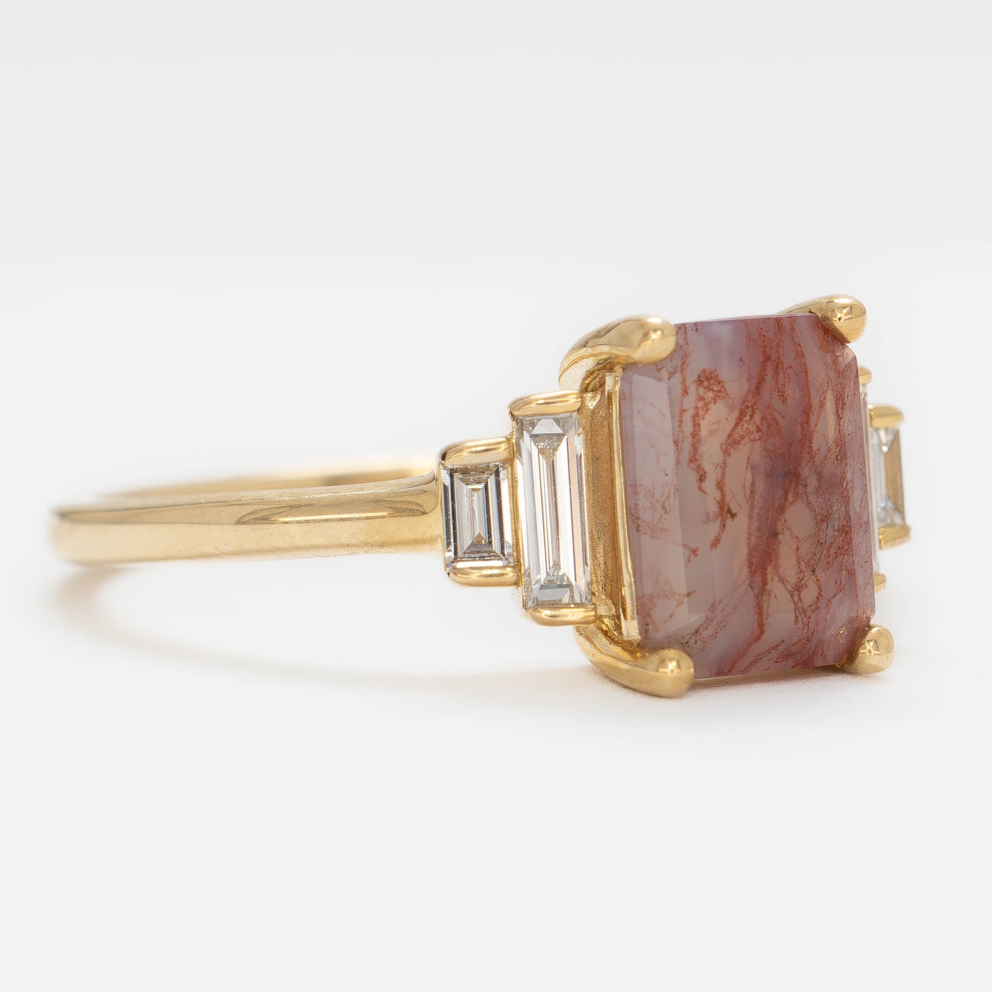 journey ring with step cut red moss agate in yellow gold