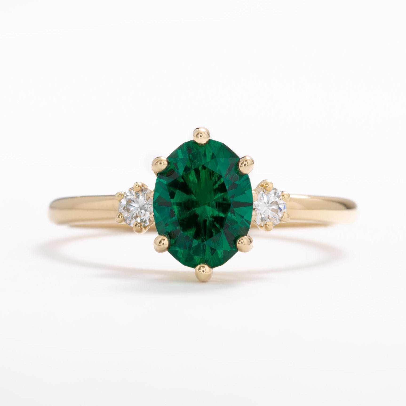 lab emerald oval three stone engagement ring