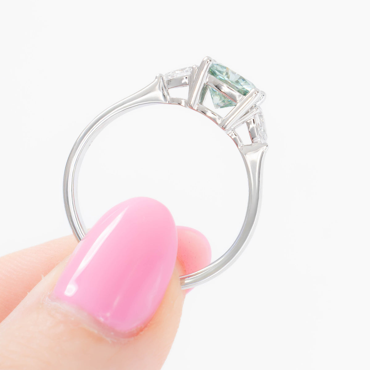lacey three stone ring with cushion blue-green moissanite