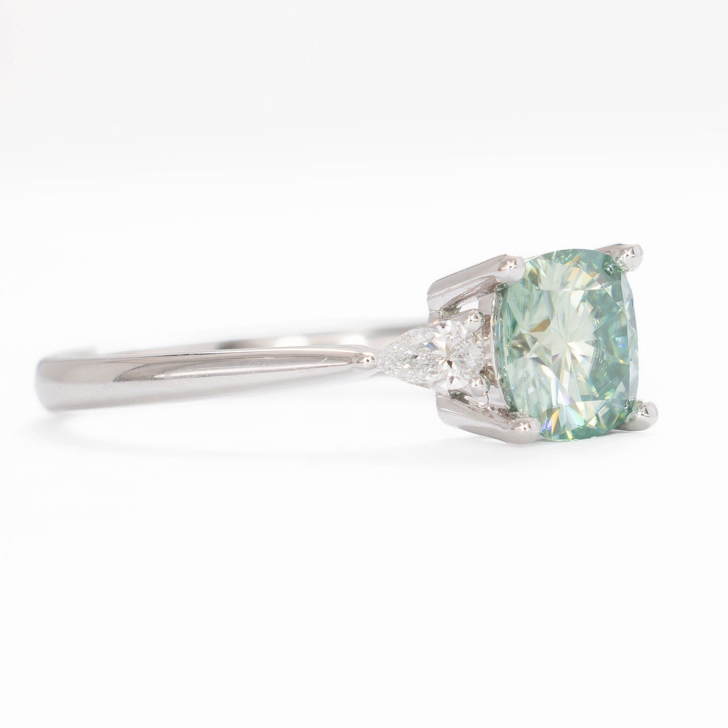 lacey three stone ring with cushion blue-green moissanite