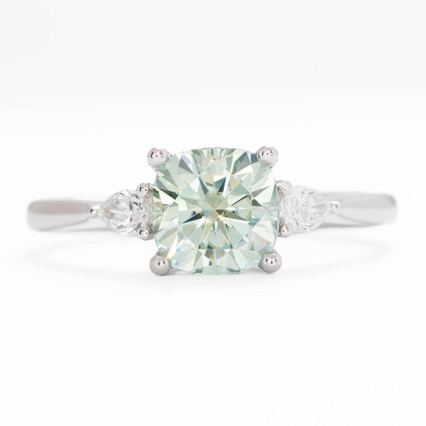 lacey three stone ring with cushion blue-green moissanite