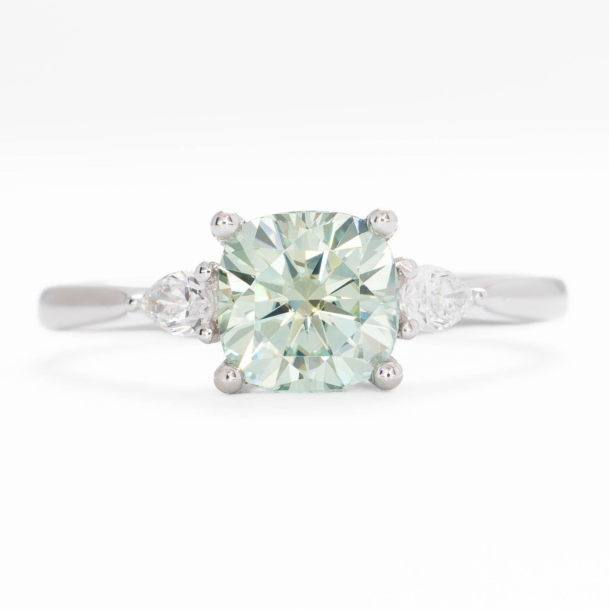 lacey three stone ring with cushion blue-green moissanite