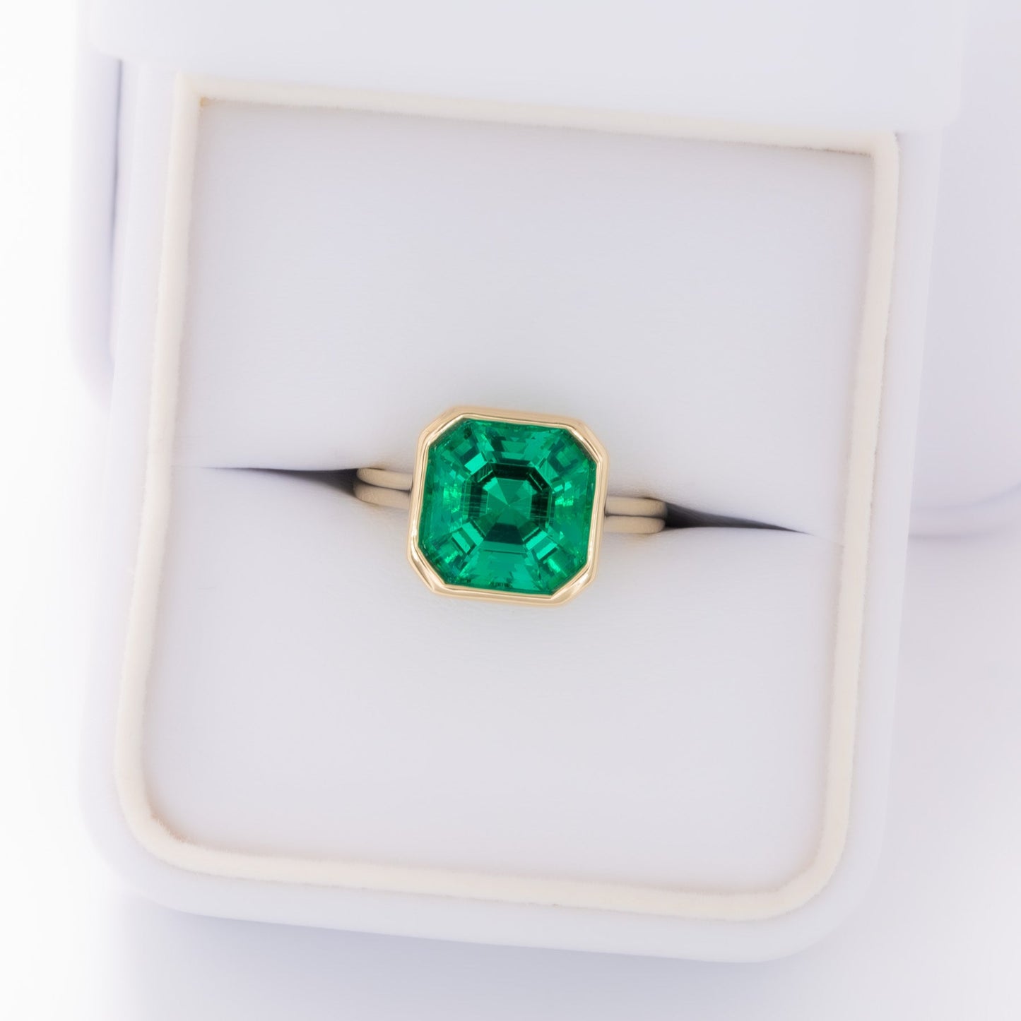 lessie bezel set solitaire with lab emerald asscher