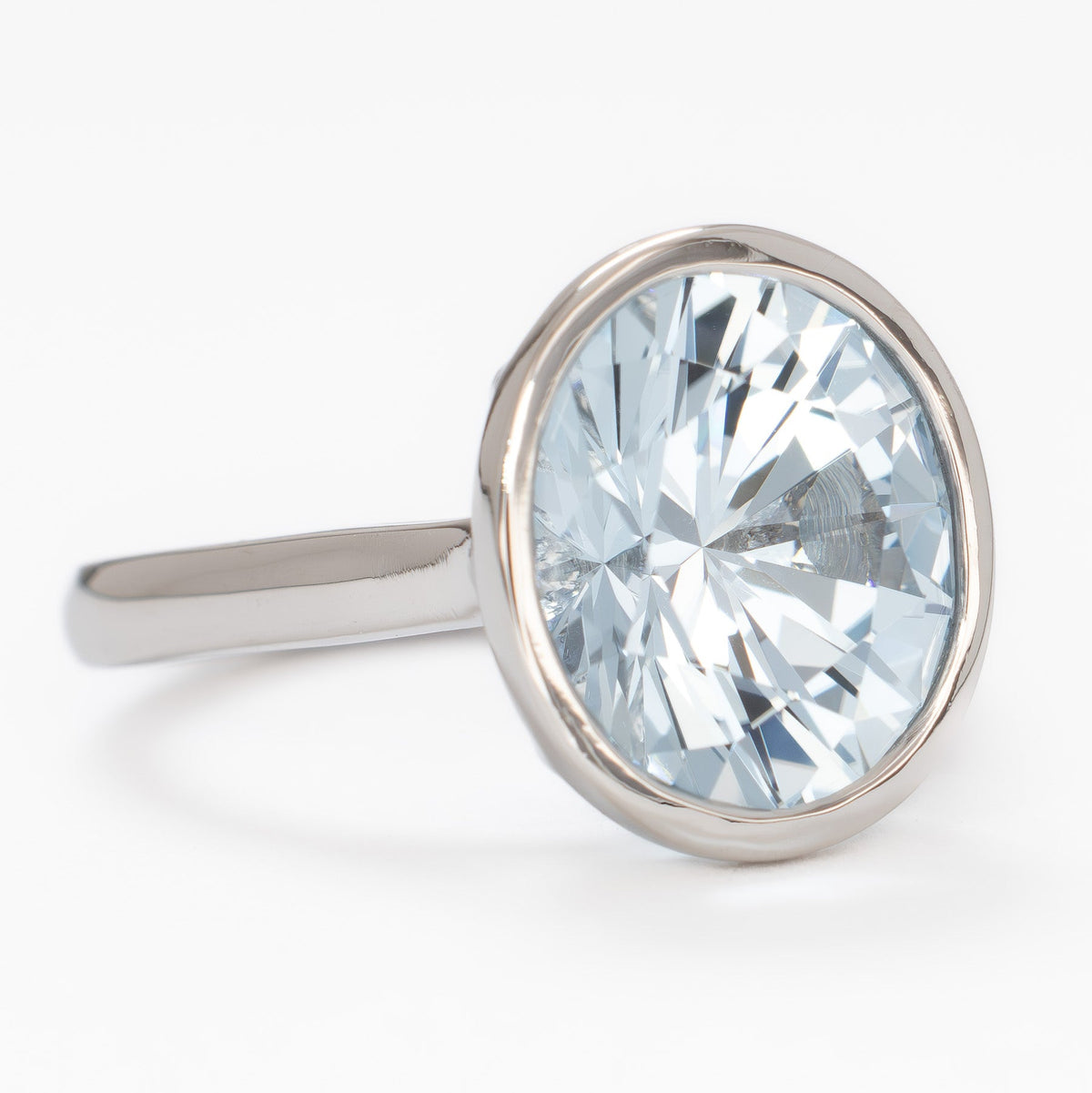lessie bezel solitaire ring in white gold with oval light blue lab sapphire