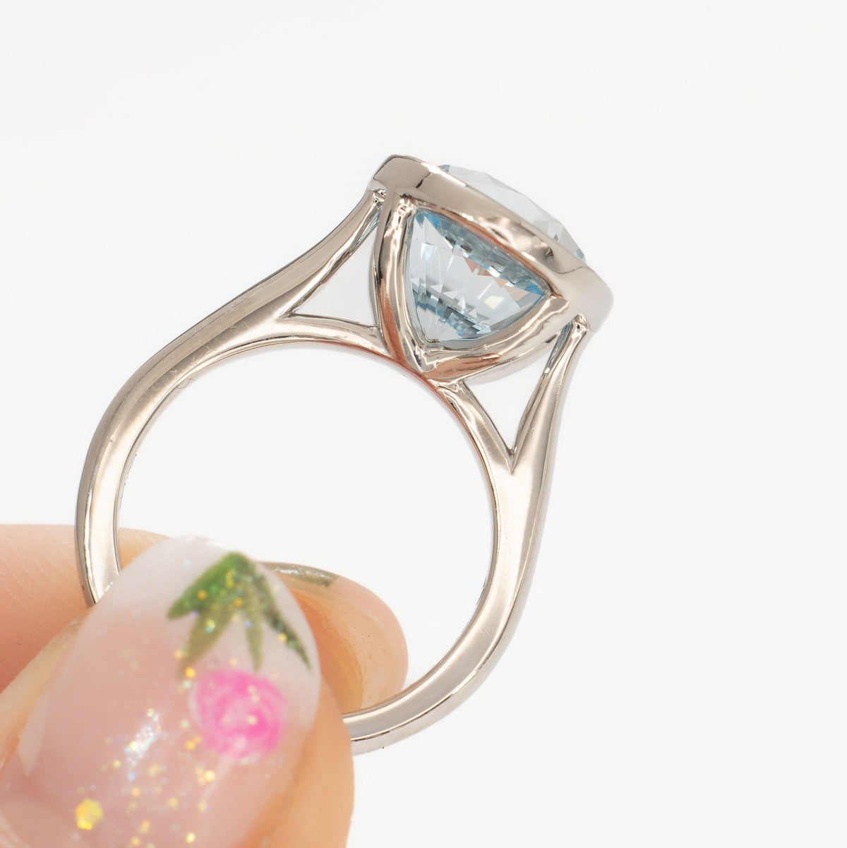 lessie bezel solitaire ring in white gold with oval light blue lab sapphire