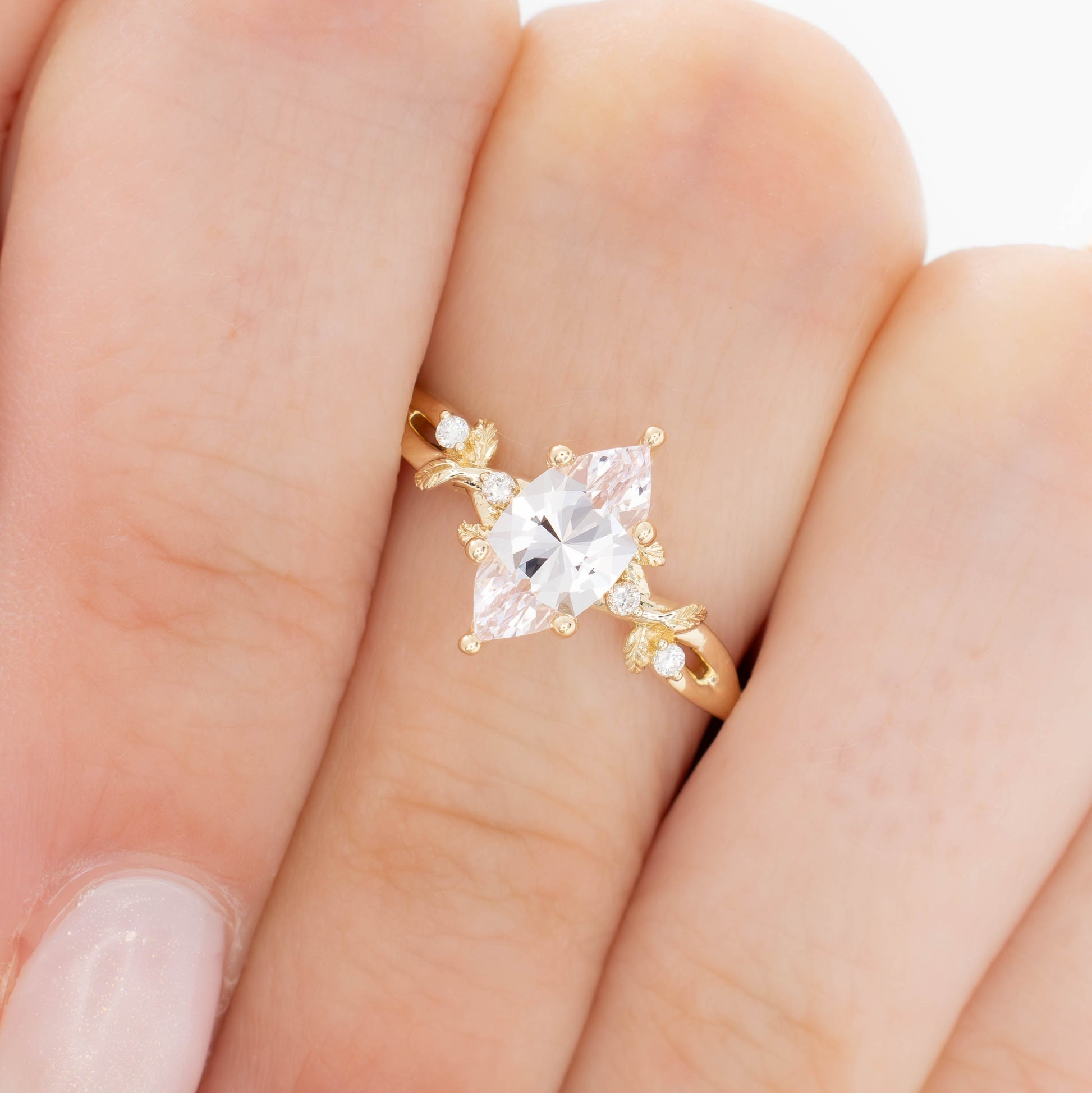 A beautiful garden to be worn everyday, Lillian's delicate vines and leaves will hold your perfect gem as well as your heart.