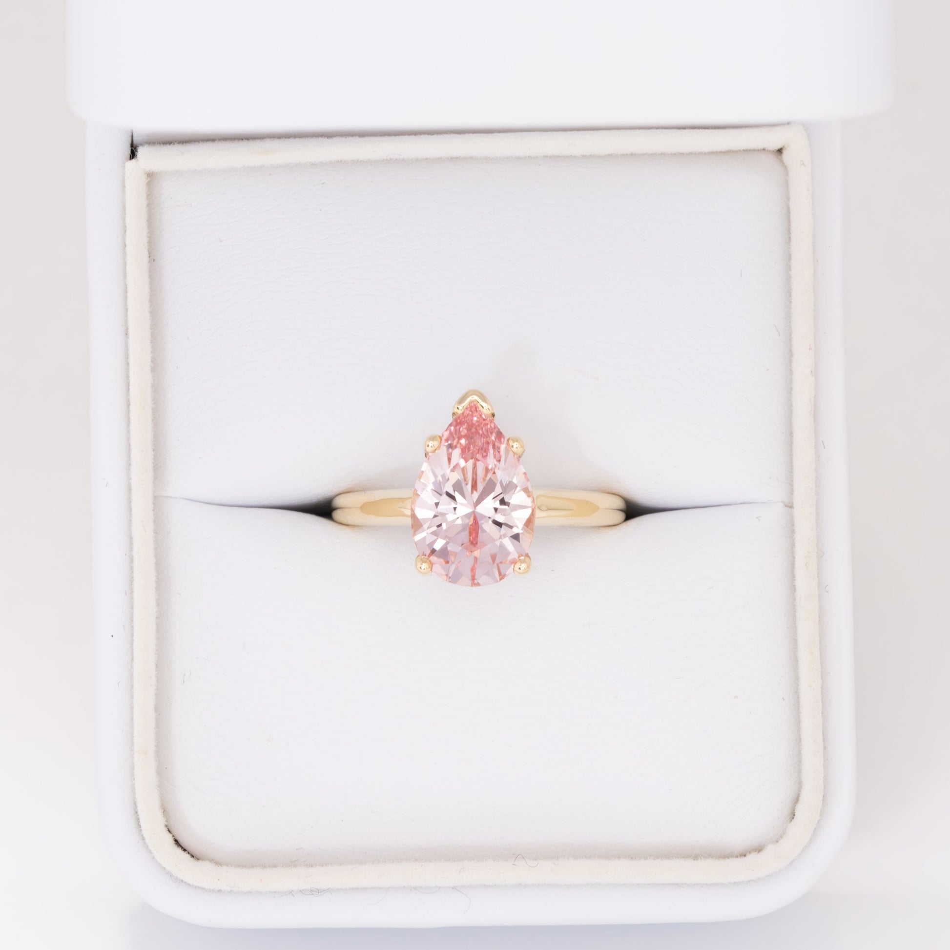 liv solitaire ring with peach lab sapphire pear