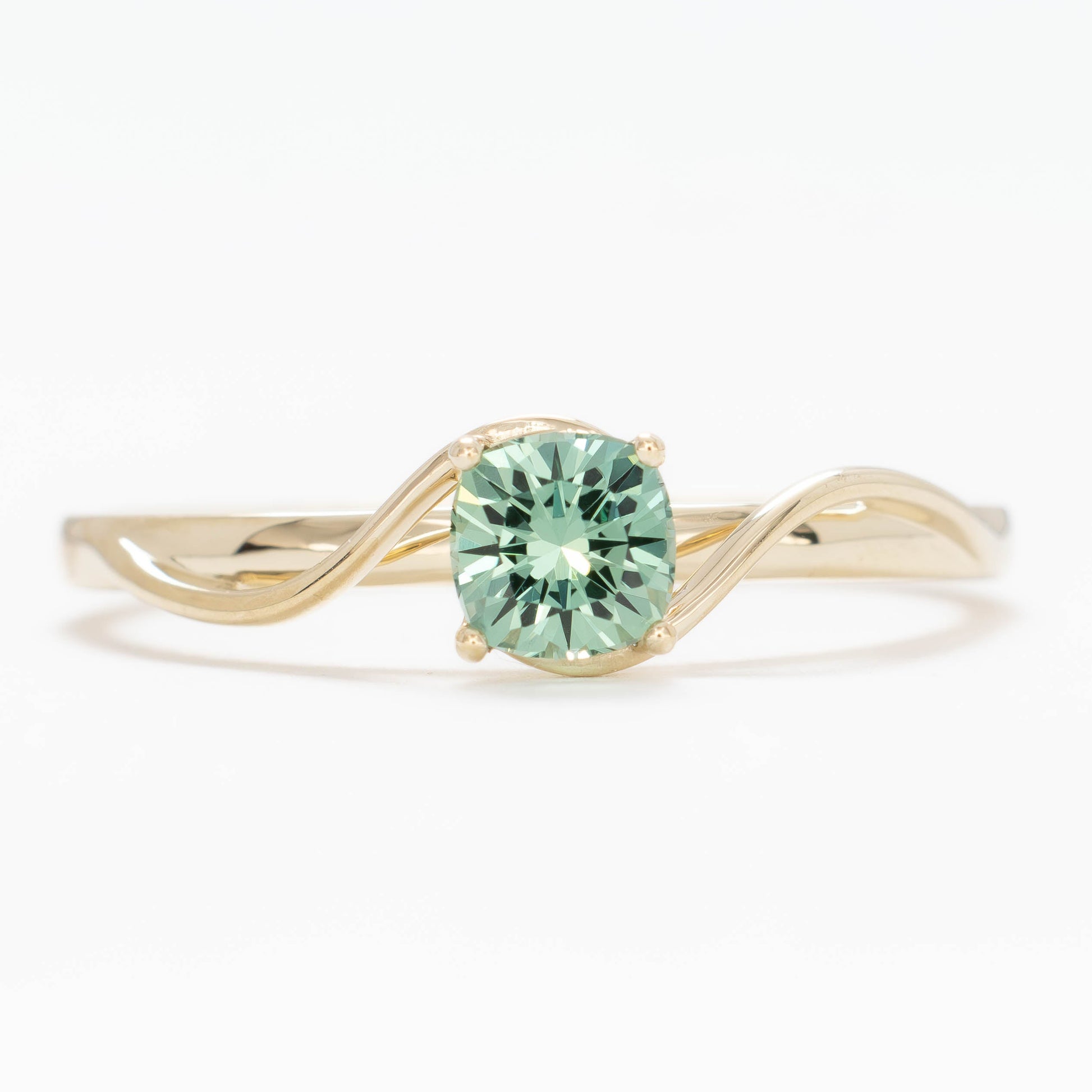 liyana solitaire bypass engagement ring with green lab sapphire cushion