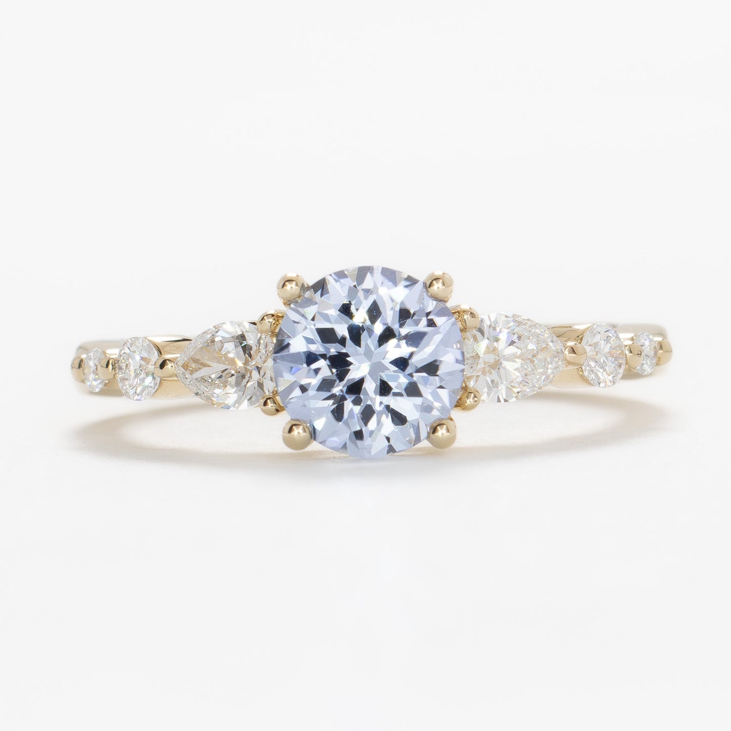 maeve ring in yellow gold with light blue round lab sapphire