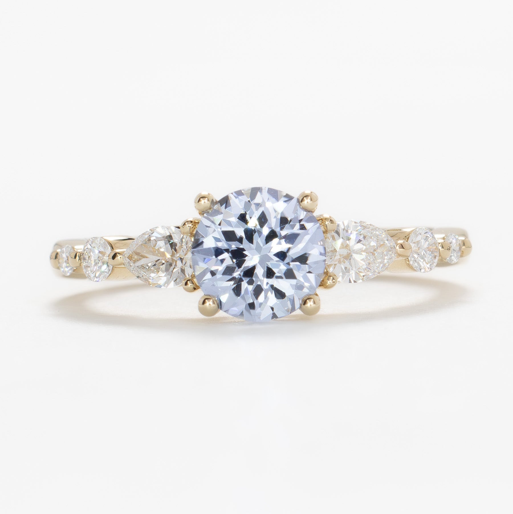 maeve ring in yellow gold with light blue round lab sapphire
