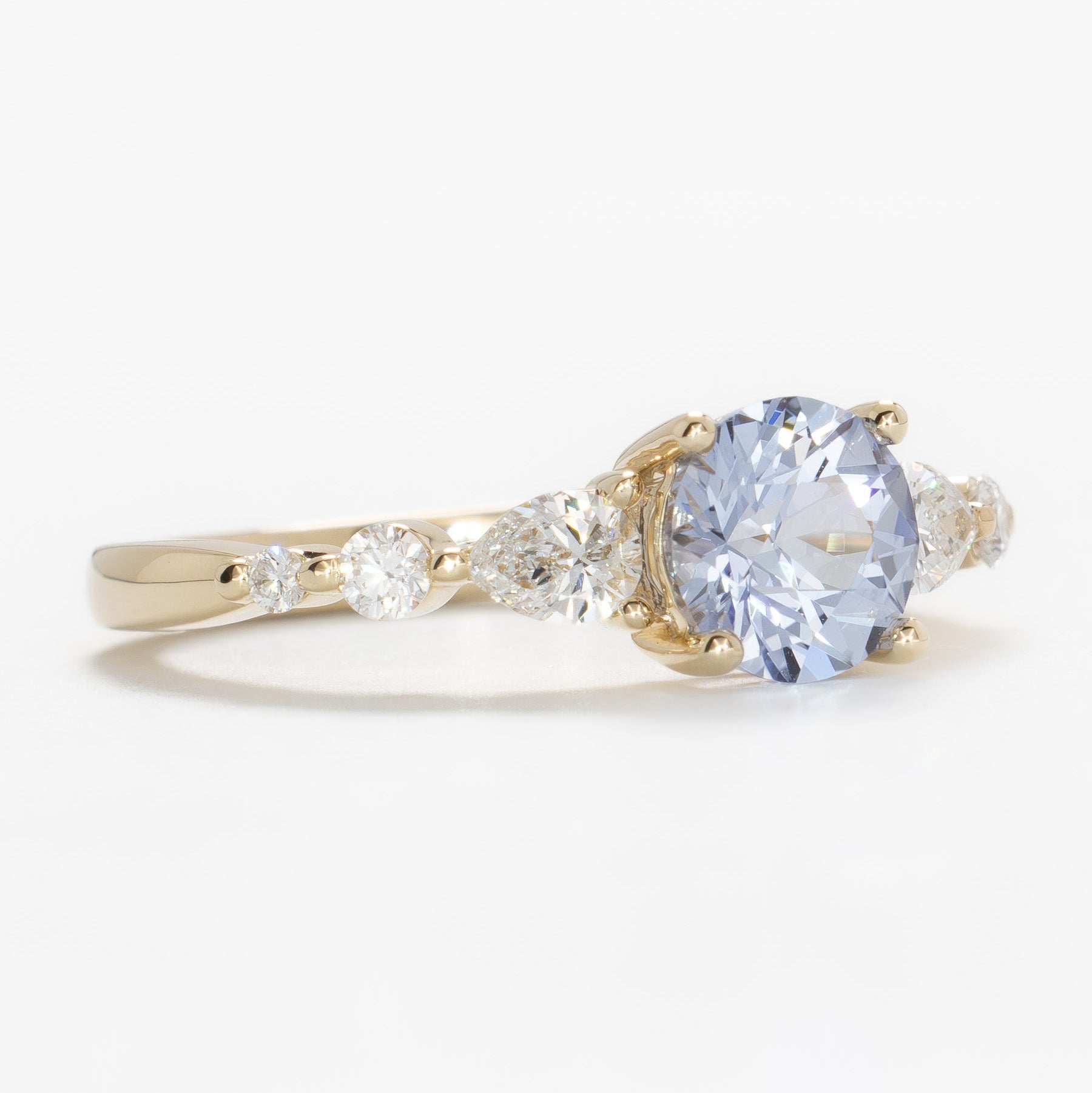 maeve ring in yellow gold with light blue round lab sapphire