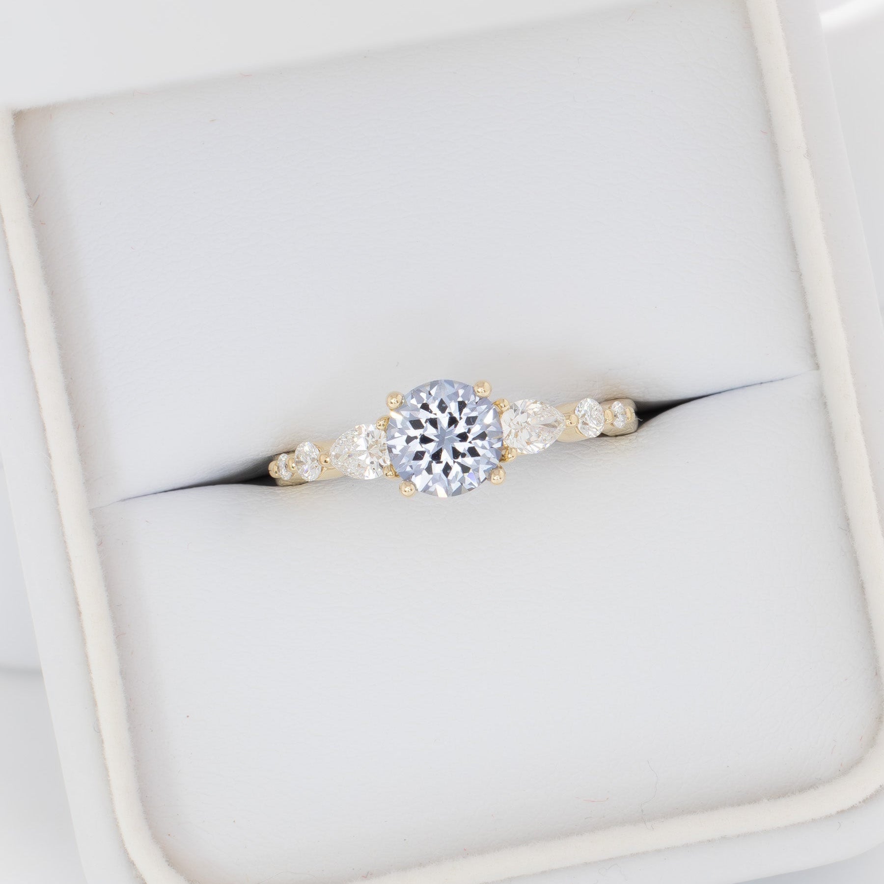 maeve ring in yellow gold with light blue round lab sapphire