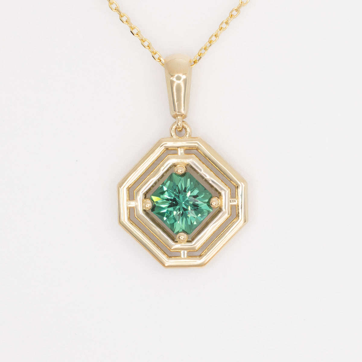 milan geometric necklace in yellow gold with green lab sapphire asscher