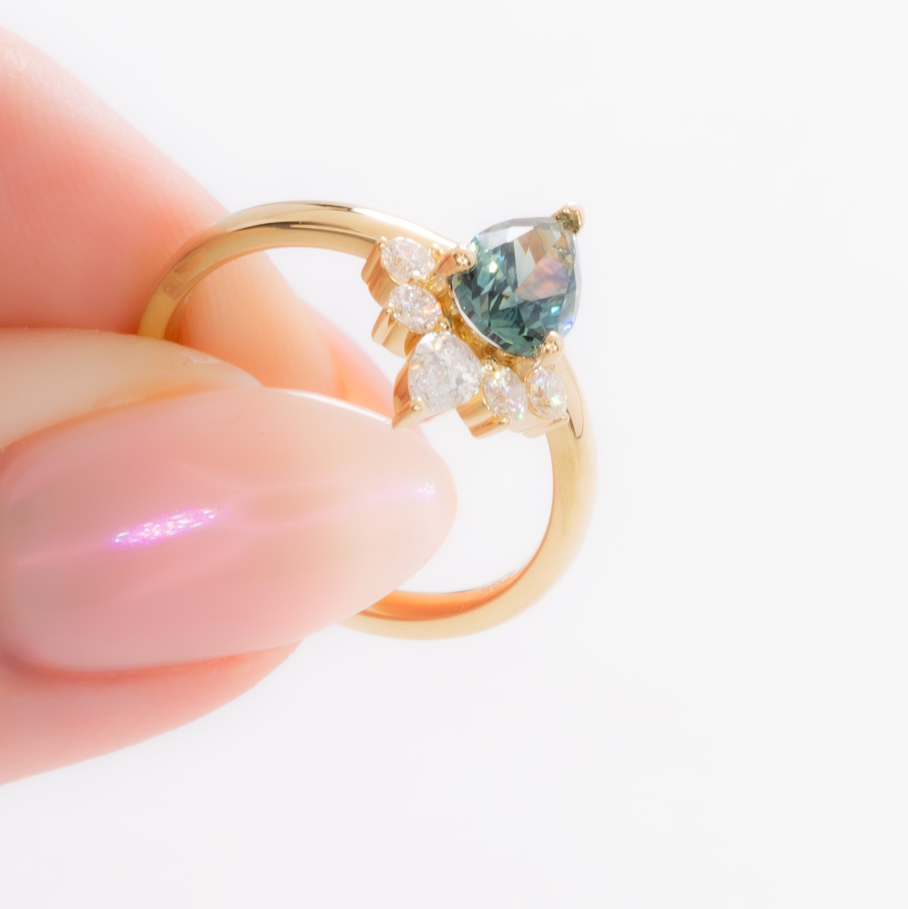 miley engagement ring with pear cut green sapphire