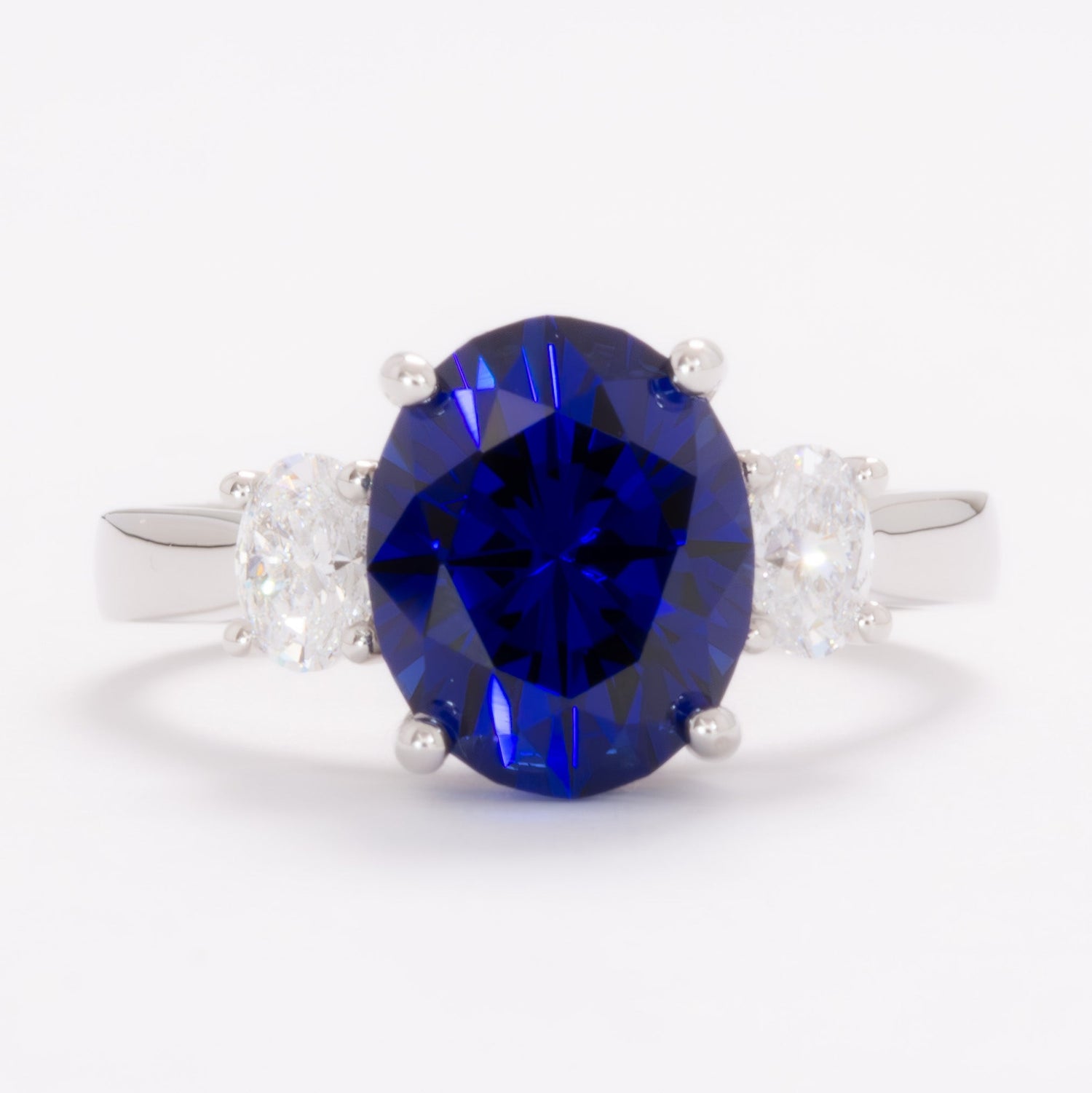 milly three stone engagement ring with oval royal blue lab sapphire