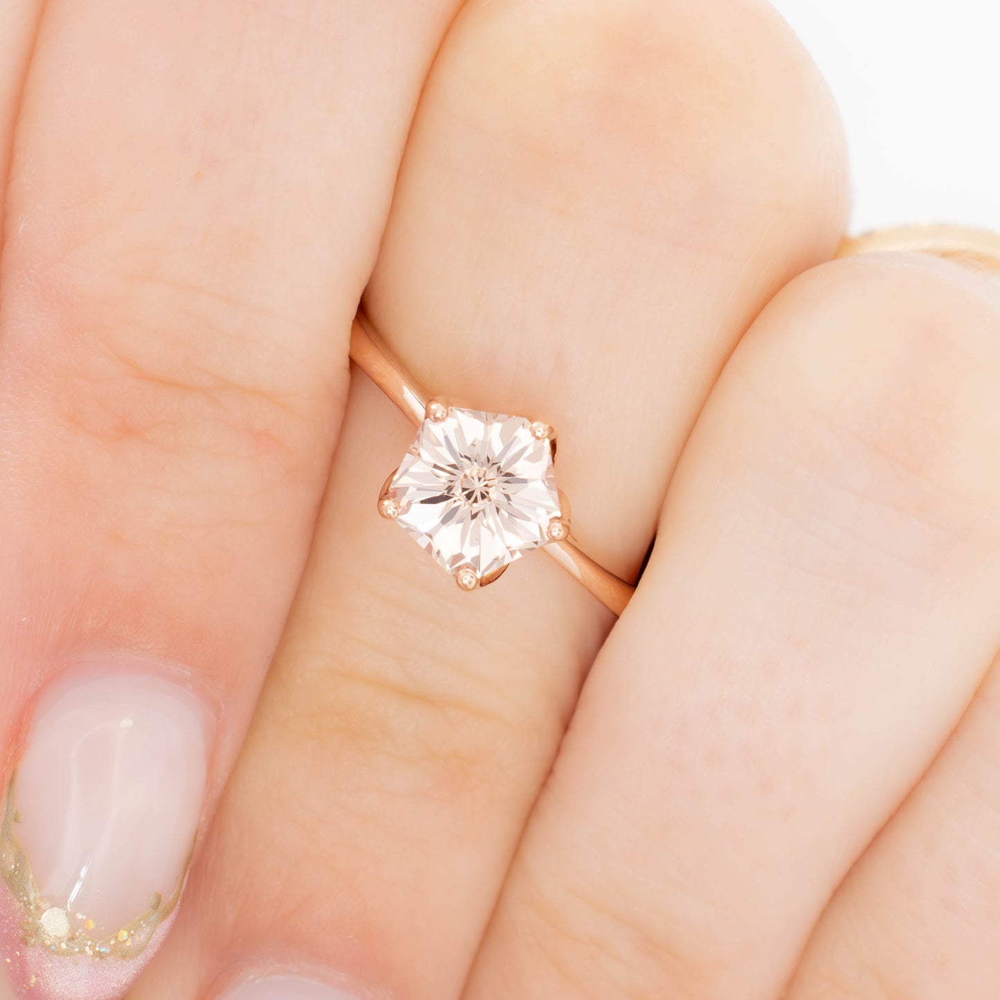 misha solitaire in rose gold with petal basket and pink lab sapphire flower
