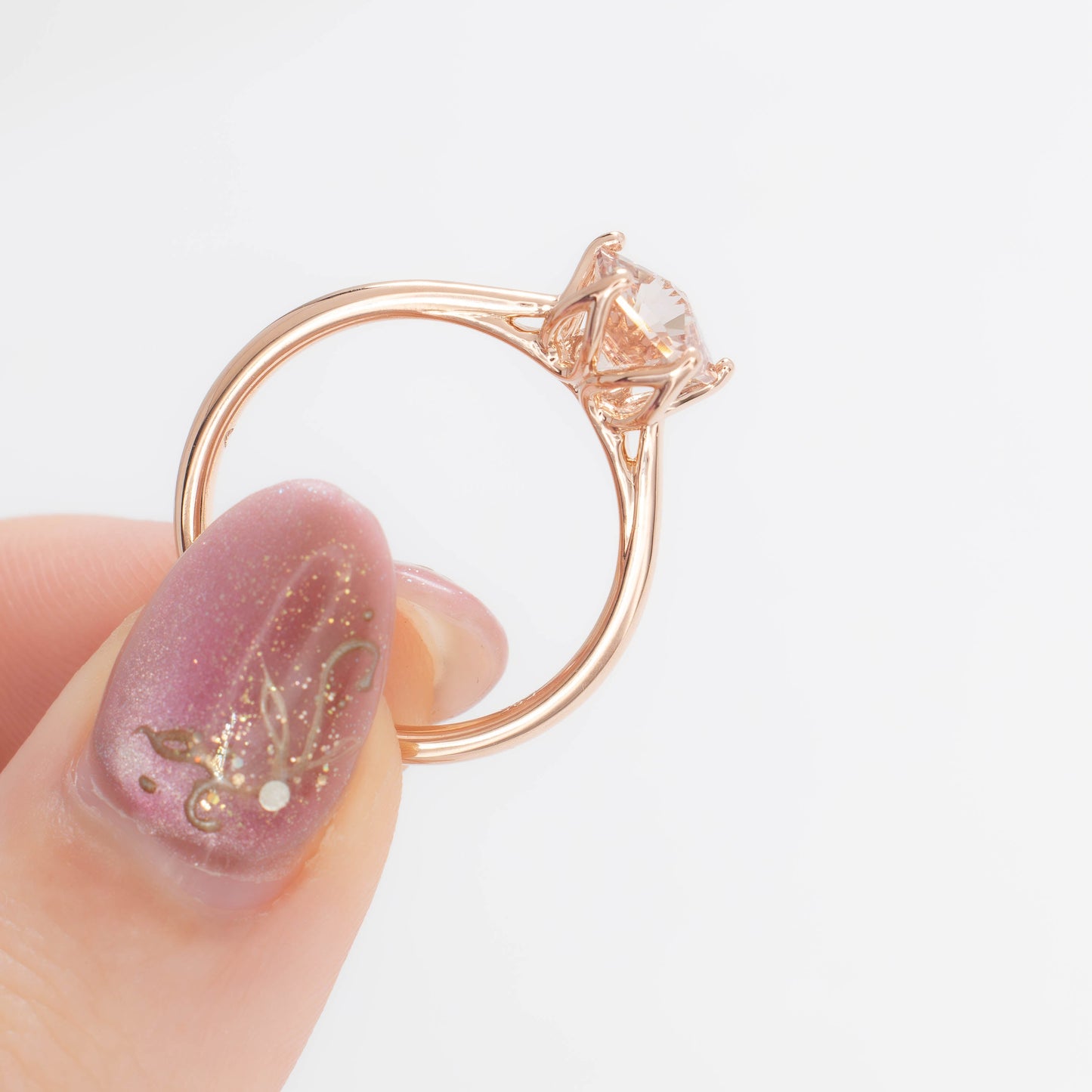 misha solitaire in rose gold with petal basket and pink lab sapphire flower