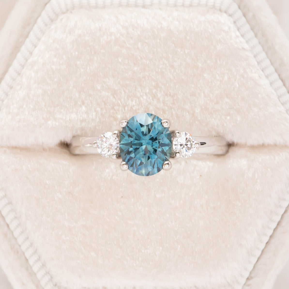 three stone engagement ring with montana sapphire oval