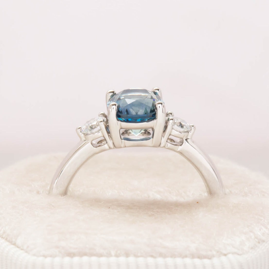 three stone engagement ring with montana sapphire oval