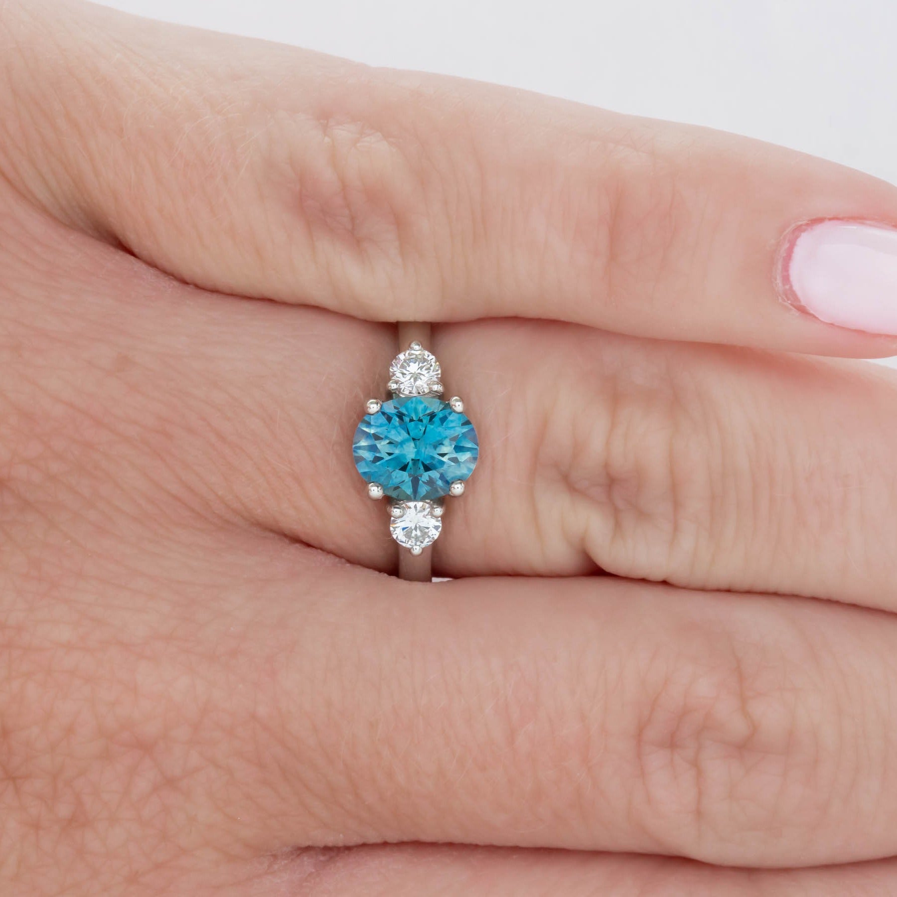 three stone engagement ring with montana sapphire oval